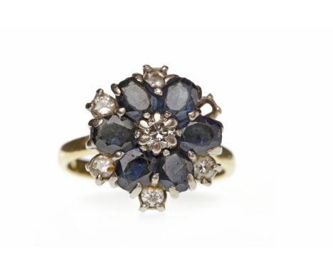 SAPPHIRE AND DIAMOND CLUSTER RING set with oval sapphires interspaced by round brilliant cut diamonds, in eighteen carat gold