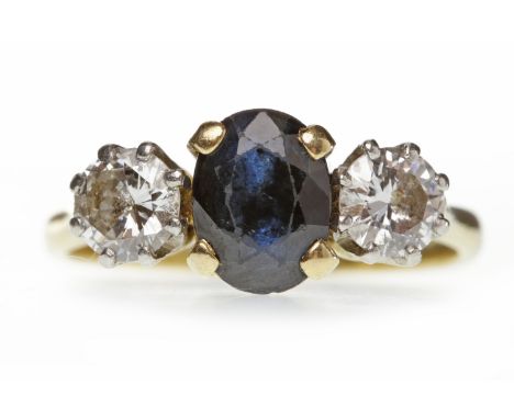 SAPPHIRE AND DIAMOND THREE STONE RING with a central oval sapphire approximately 8x6mm, flanked by two round brilliant cut di