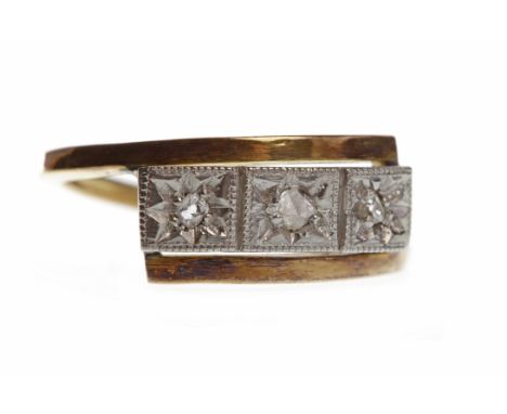MID TWENTIETH CENTURY DIAMOND THREE STONE RINGthe rectangular bezel with three star set round diamonds, size K, marks indisti
