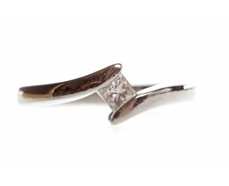 PLATINUM DIAMOND SOLITAIRE RINGwith a tension set princess cut diamond of approximately 0.20 carats, size K, 6.2g