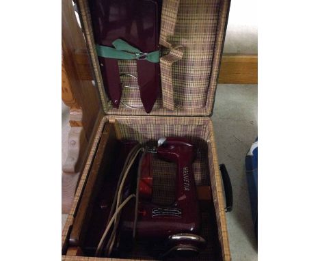 A cased vintage Helvetia Swiss sewing machine.