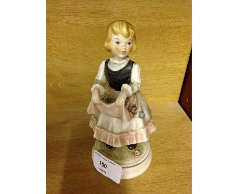 A Goebel figure of a girl with flowers in her apron.