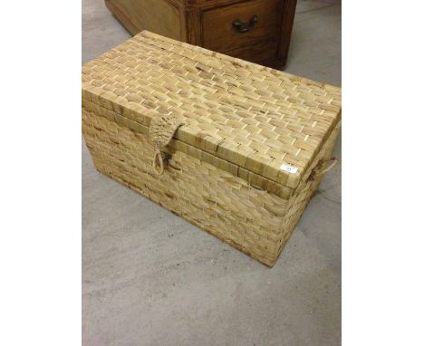 A large rafia storage trunk.