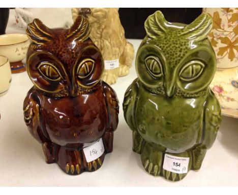2 ceramic owl money boxes - one green, the other brown, each 21cm tall.