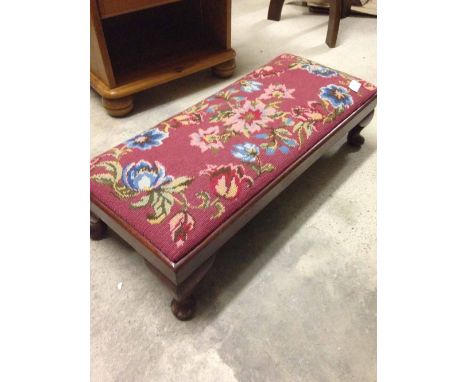 A vintage double footstool/kneeler with red tapestry cover.