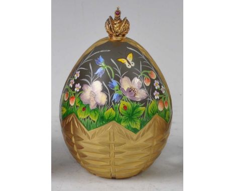 Theo Faberge for The St Petersburg Collection - a decorative solid glass egg, with gilt metal crown finial, relief cut height