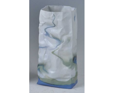 An unusual contemporary French ceramic vase in the form of a crumpled paper bag, decorated in tones of green and blue, indist