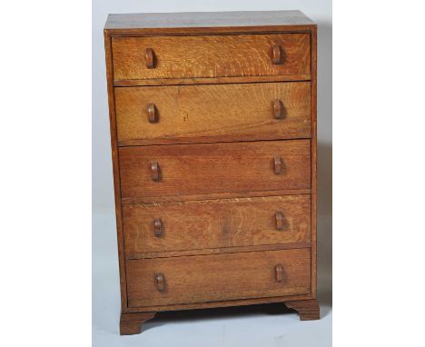 An Art Deco oak chest of five long drawers, having curved handles, h.117cm, w.76cm, d.43cmCondition report: Stands well and i