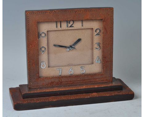 A 1930s Asprey's of London leather stitch clad mantel clock, having eight-day winding movement, silvered hands and numbers, t