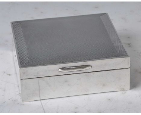 A 1960s silver engine turned square table cigarette box, with engine turned cover and cedar lined interior, maker Turner &amp