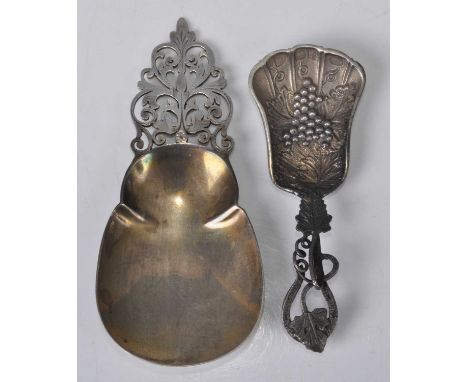 An Arts &amp; Crafts silver caddy spoon, having stylised floral pierced and engraved handle to shaped flattened bowl, maker M