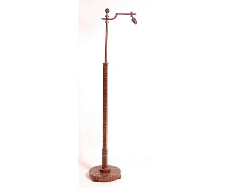 An Art Deco 'Calamander' standard lamp, having telescopic action, raised on a circular stepped base, max h.160cm