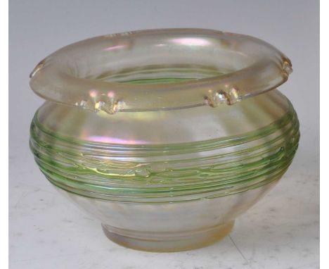 Possibly Loetz - an early 20th century iridescent footed table bowl, the folded rim with pinched detail to squat bulbous body