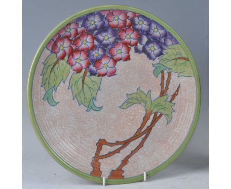 A 1930s Charlotte Rhead pottery circular charger, tube-line and bright colour floral decorated, of ribbed form, signed and nu