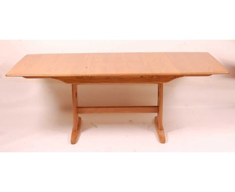 A contemporary Ercol light elm extending dining table, having pull-out action and single fold-out leaf, max length 200cm, h.7