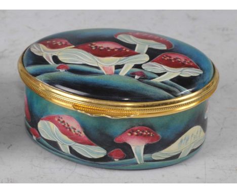 A contemporary Moorcroft Enamels oval lidded patch box, in the Toadstool pattern, gilt metal mounted, printed marks verso, bo