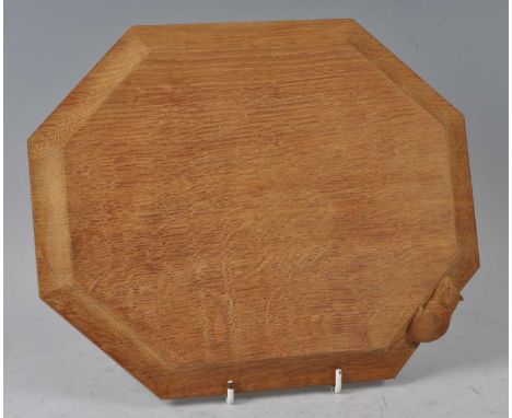 Robert 'Mouseman' Thompson - an oak octagonal cheese board, having thumb moulded edge with typical carved attendant mouse, 30