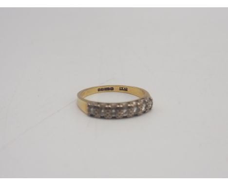 An 18ct 7-stone Eternity Band, weight = 3.0 grams, ring size = M