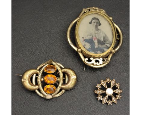THREE GOLD PLATED BROOCHESone a locket with central glazed photograph panel, another set with seed pearl and mother of pearl;