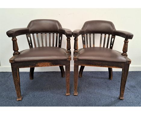 PAIR OF ARTS AND CRAFTS ARMCHAIRSwith a shaped top rail above a flat stick back with a padded seat below, covered with synthe