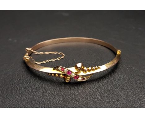 EDWARDIAN SEED PEARL AND RED GEM SET BANGLEthe hinged bangle with safety chain, Birmingham hallmarks for 1906, approximately 