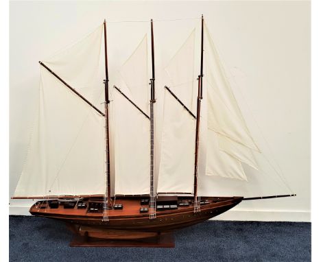 SCALE MODEL OF A SCHOONERwith three masts and rigging, of teak construction with stand, 201cm long 