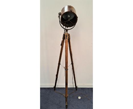 FREESTANDING SPOT LIGHT LAMPon a mahogany tripod base marked to each leg 'J.W', the brass cylindrical lamp with adjuster arm,