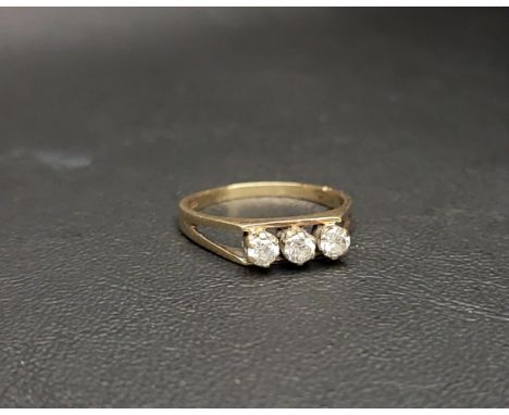 THREE STONE NINE CARAT GOLD RING the three CZ stones flanked by pierced shoulders, approximately 2.5 grams, ring size Q-R 