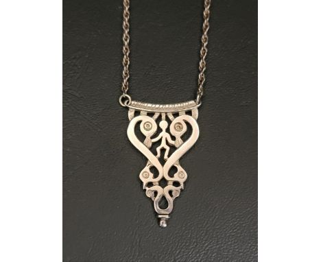 OLA GORIE SILVER PENDANT ON CHAINthe pierced pendant with stick figure surrounded by scrolling detail, on attached chain 