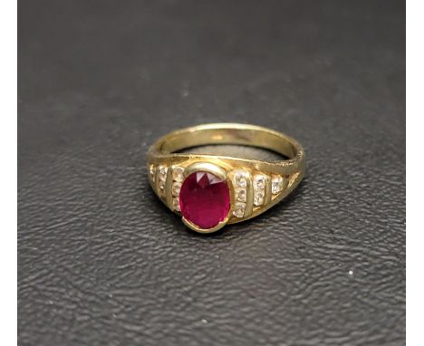 EIGHTEEN CARAT GOLD DIAMOND AND RUBY RINGthe central oval cut ruby with diamond set shoulders in a cascading step design, app