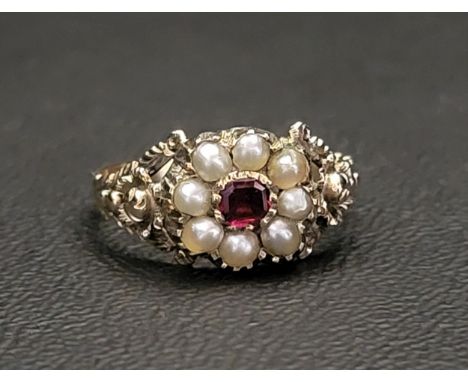 VICTORIAN GARNET AND SEED PEARL CLUSTER RINGon unmarked gold shank with floral decorated shoulders, ring size O 