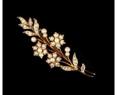 A HALF PEARL SPRAY BROOCH, designed as a spray of half pearl set flowerhead clusters and foliage, stamped '15ct', (later fitt
