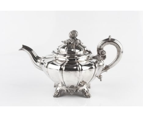 A WILLIAM IV SILVER TEAPOT, of shaped and lobed form, the domed cover with cast gourd and leaf finial, having scroll handle, 