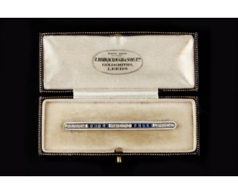 AN EARLY 20TH CENTURY SAPPHIRE, DIAMOND AND ENAMEL BAR BROOCH, millegrain set with a line of rectangular step-cut sapphires a