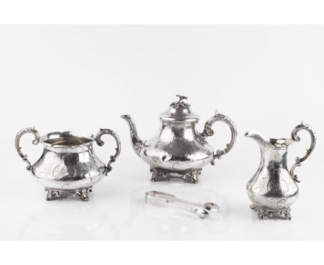 AN EARLY VICTORIAN SILVER THREE PIECE TEA SERVICE, engraved with foliage and 'C' scrolls, and with flower finial, by Edward, 