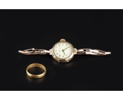 A LADY'S 9CT GOLD CASED BRACELET WATCH, retailed by Sharman D. Neill Ltd, the circular dial with Arabic numerals and outer mi