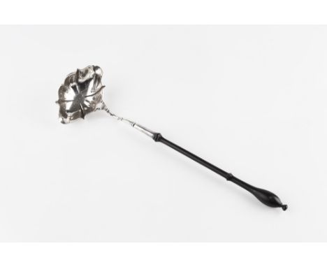 A GEORGE III SILVER TODDY LADLE, with shaped elongated bowl, crested to the underside, and with turned ebonised handle, maker