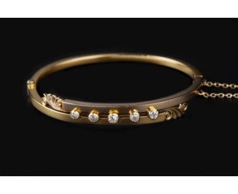 A DIAMOND SET BANGLE, of hinged form and crossover design, centred with a line of graduated old-cut diamonds in collet settin