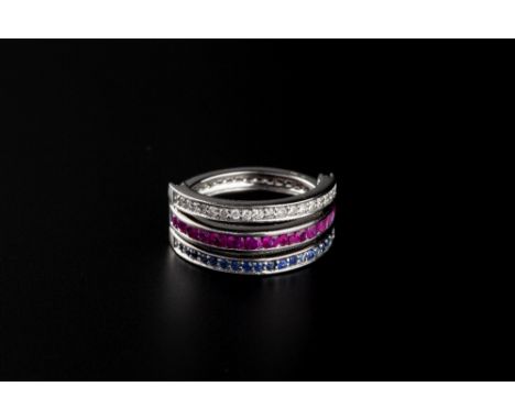 A RUBY, SAPPHIRE AND DIAMOND SWIVEL RING, centred with a line of round brilliant-cut diamonds to one side and circular mixed-