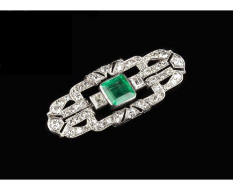 AN ART DECO EMERALD AND DIAMOND PANEL BROOCH, the stepped rectangular panel of openwork geometric design, millegrain set thro