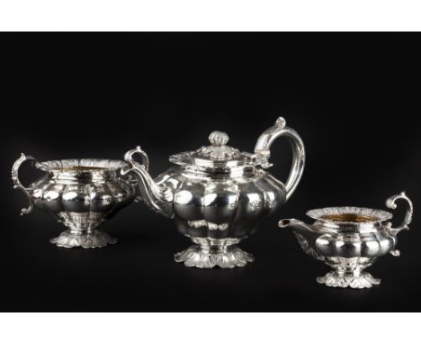 A GEORGE IV/WILLIAM IV SILVER THREE PIECE TEA SERVICE, of lobed design, with anthemion and foliate cast borders, the teapot b