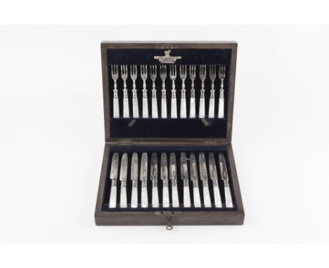 A SET OF TWELVE SILVER FRUIT KNIVES AND FORKS, with mother of pearl handles, by Martin Hall &amp; Co Ltd, Sheffield 1918, in 