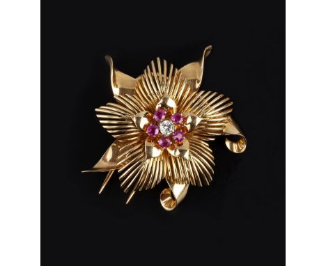 A FRENCH RUBY AND DIAMOND CLIP BROOCH, circa 1940, of stylised flowerhead design, centred with a round brilliant-cut diamond 