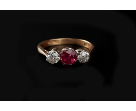 A SYNTHETIC RUBY AND DIAMOND THREE STONE RING, the circular mixed-cut synthetic ruby claw set between two old-cut diamonds, 1