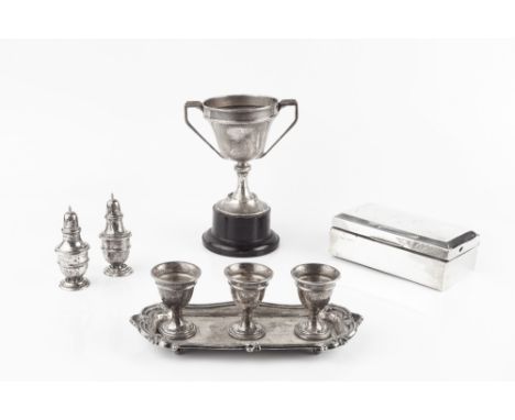 AN EDWARDIAN SILVER TRIPLE EGG STAND, the three egg cups on rectangular tray base, with foliate cast border by Mappin &amp; W