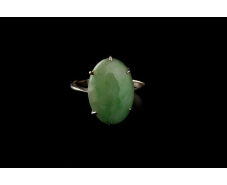 A JADE SINGLE STONE RING, the oval jade cabochon in six claw setting, white precious metal mounted, (jade untested for treatm