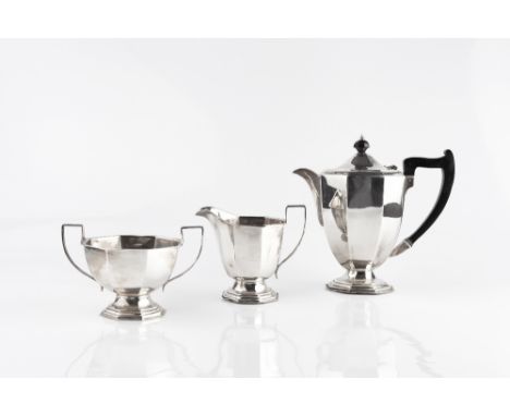 A MATCHED SILVER THREE PIECE TEA SERVICE, of octagonal baluster form, the hot water pot with ebonised handle and knop, teapot