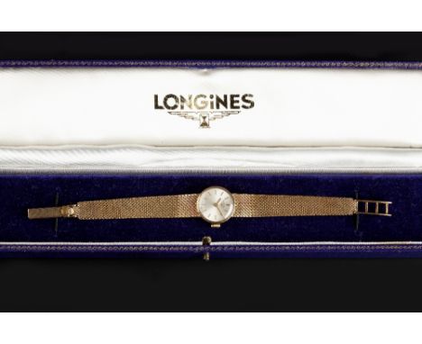 A LADY'S 9CT GOLD BRACELET WATCH BY LONGINES, the circular signed silvered dial with baton markers, to a signed jewelled manu