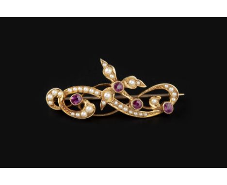 A RUBY AND HALF PEARL PANEL BROOCH, the circular and cushion-shaped mixed-cut rubies in millegrain collet settings, to an ope