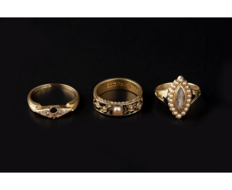 TWO VICTORIAN MEMORIAL RINGS, the first with a navette-shaped hairwork panel, bordered by half pearls, to a tapered hoop with